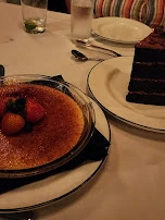 Creme Brulee and Chocolate Cake in Background